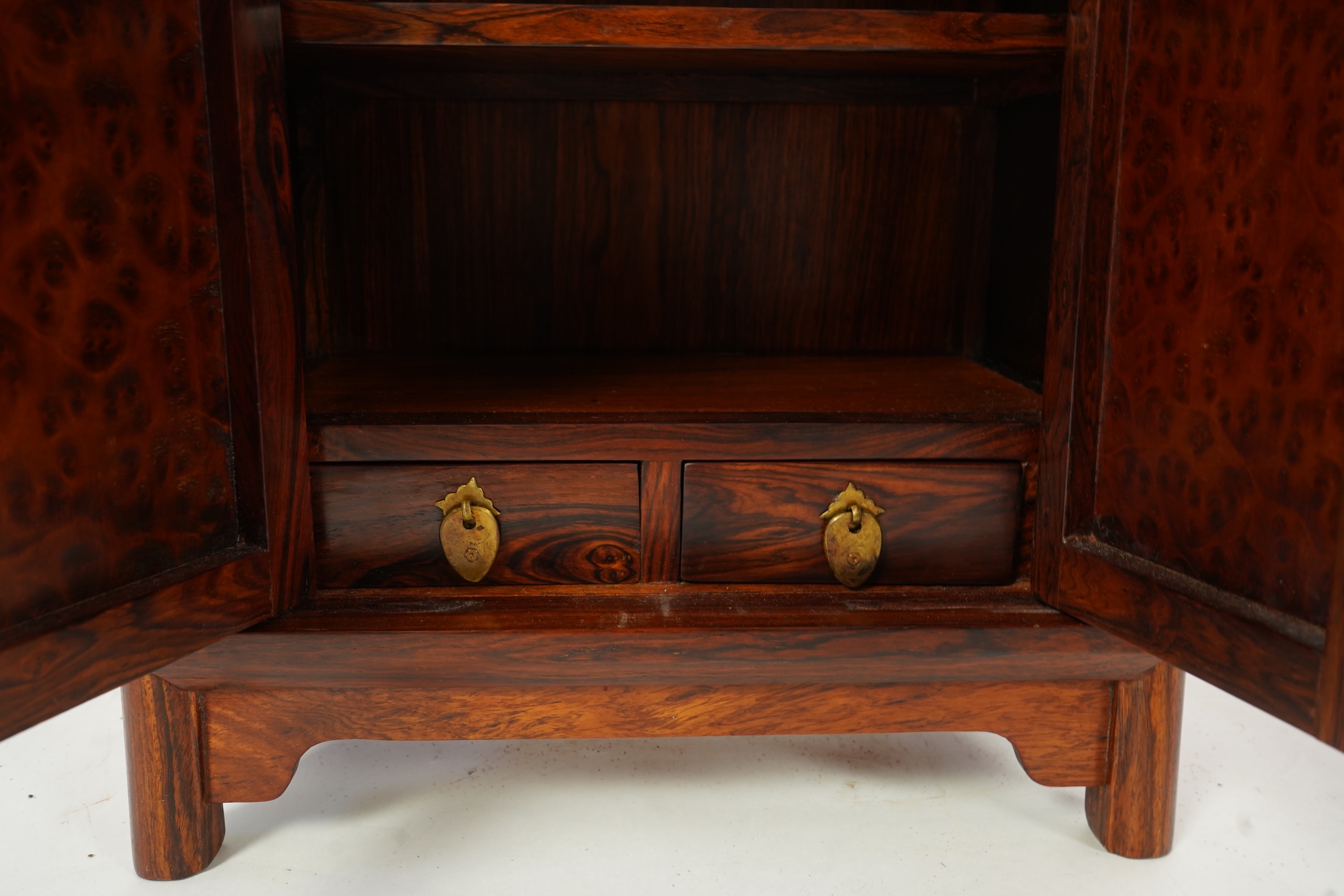 A Chinese huanghuali and burrwood panelled round-corner kang cabinet, 20th century